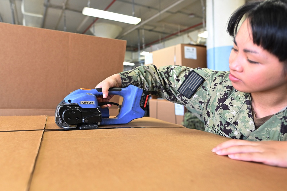 Naval Supply System Command Fleet Logistic Center Pearl Harbor prepares tri-wall postal packages for the Nimitz Carrier Strike Group