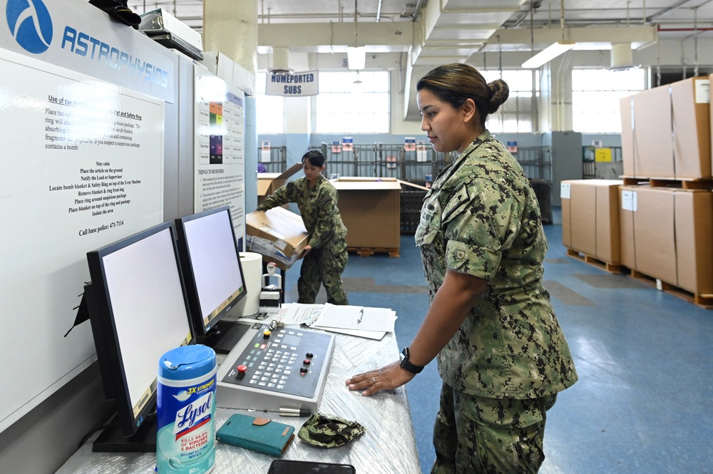 Naval Supply System Command Fleet Logistic Center Pearl Harbor prepares tri-wall postal packages for the Nimitz Carrier Strike Group