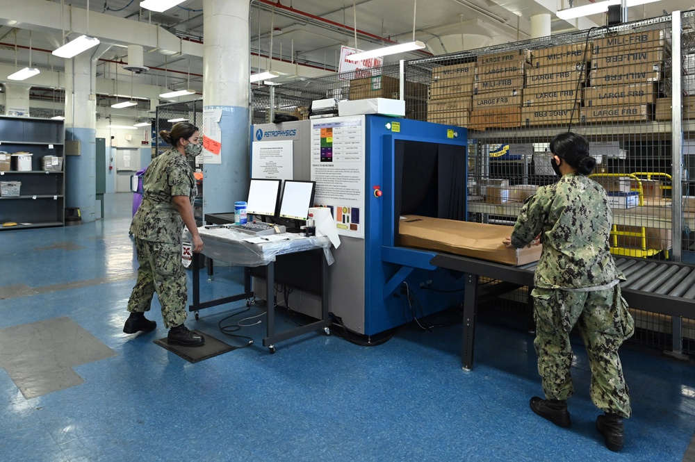 Naval Supply System Command Fleet Logistic Center Pearl Harbor prepares tri-wall postal packages for the Nimitz Carrier Strike Group