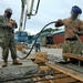 U.S. Navy Seabees with NMCB-5’s Detail Sasebo place concrete for Naval Beach Unit Seven