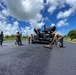Seabees with NMCB-5’s Detail Guam lay asphalt in support of Naval Computer and Telecommunications Area Master Station, Pacific