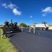 Seabees with NMCB-5’s Detail Guam lay asphalt in support of Naval Computer and Telecommunications Area Master Station, Pacific