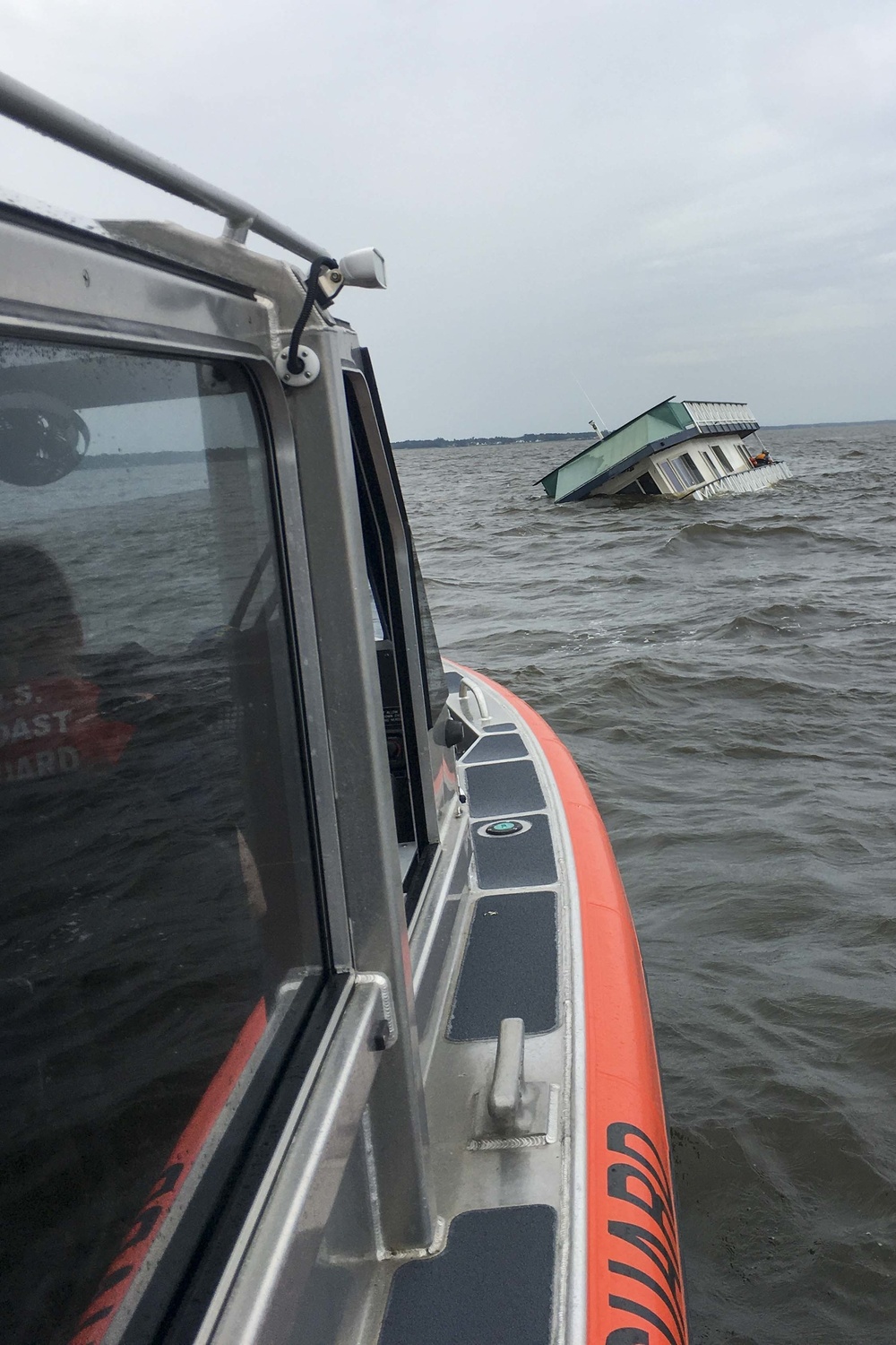 Coast Guard rescues 2 people, 1 cat from sinking houseboat