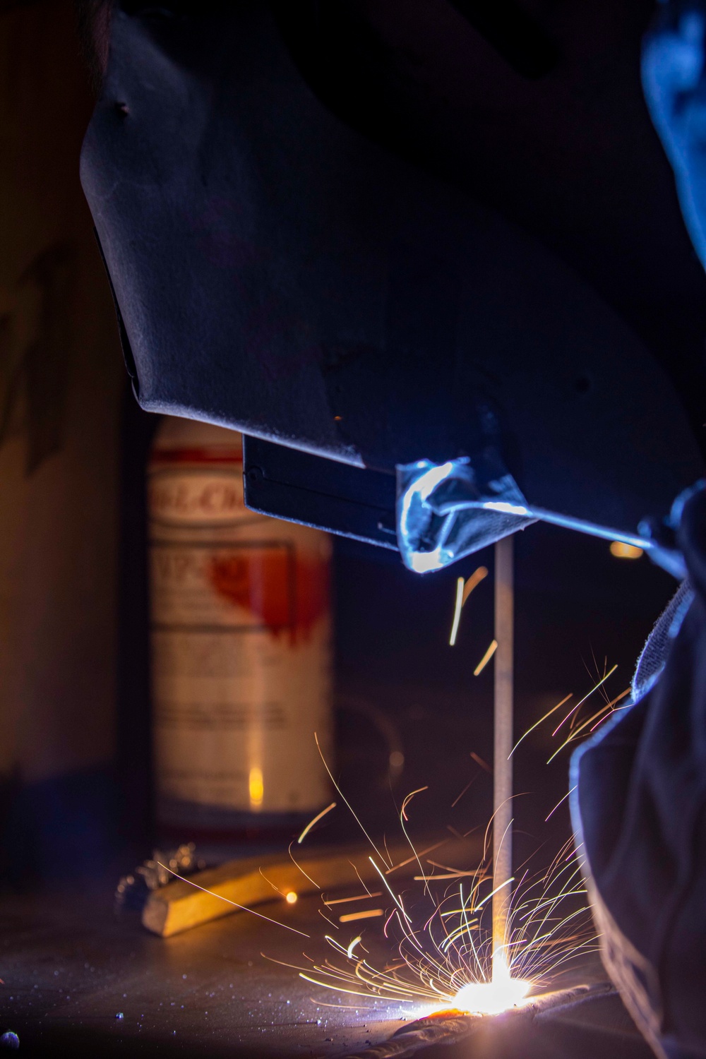 A Sailor welds aboard New York