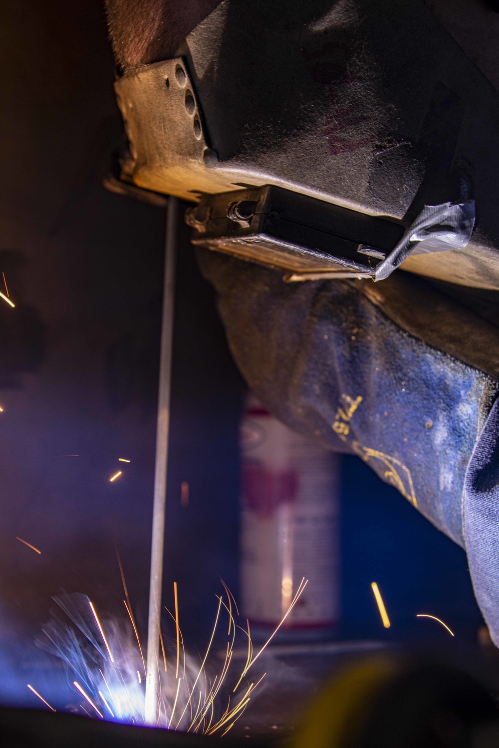 A Sailor welds aboard New York