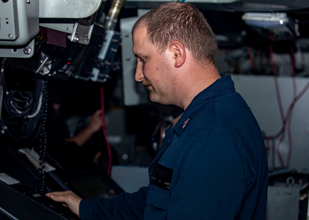 Sailors stand watch in combat