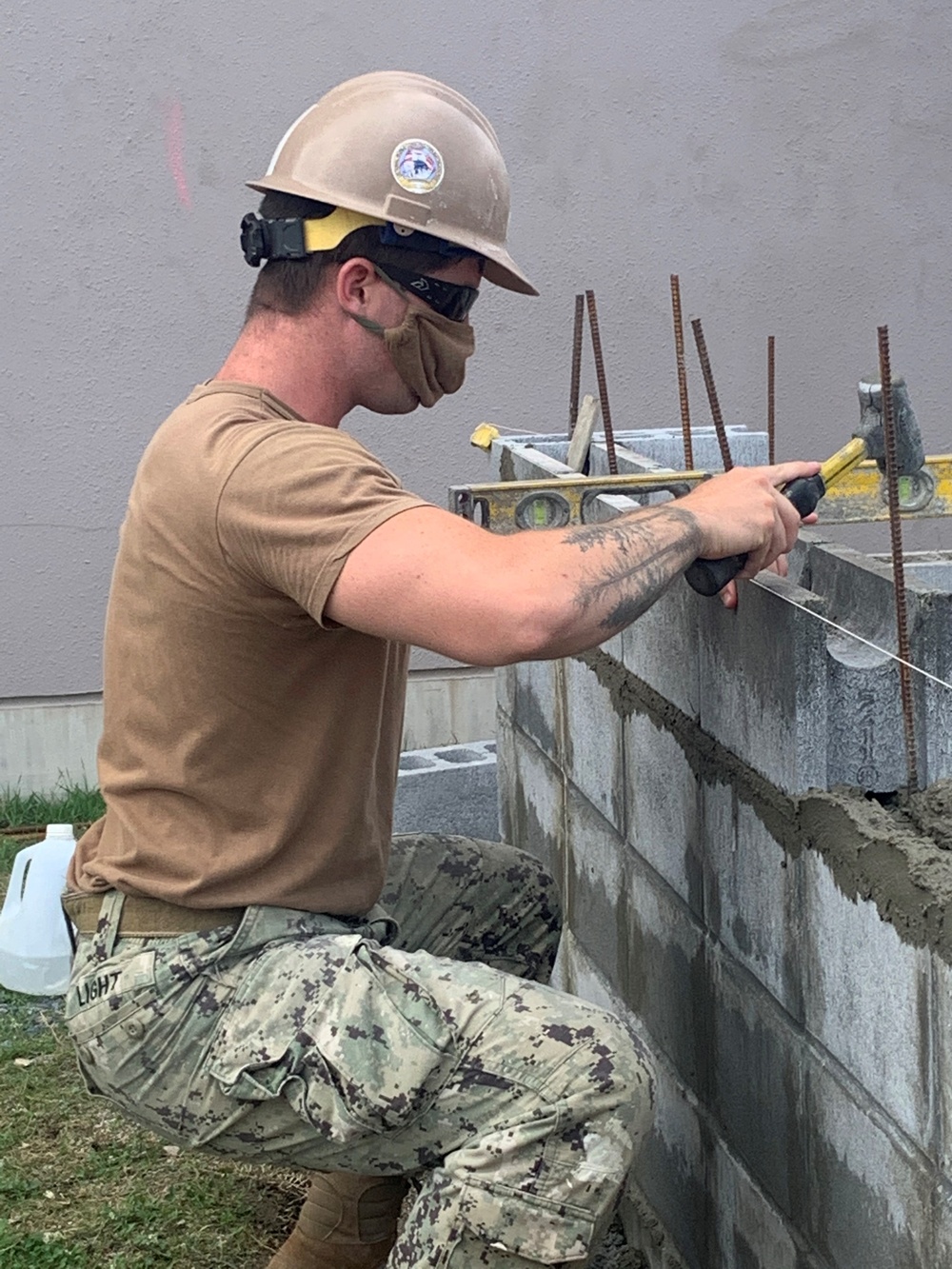 U.S. Navy Seabees with NMCB-5 build concrete masonry unit enclosures at Torii Housing onboard Marine Corps Air Station, Iwakuni