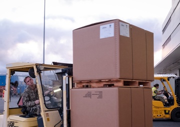 Naval Supply System Command Fleet Logistic Center Pearl Harbor prepares tri-wall postal packages for the Nimitz Carrier Strike Group