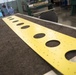 Maintainers repair corrosion on aircraft cargo ramp