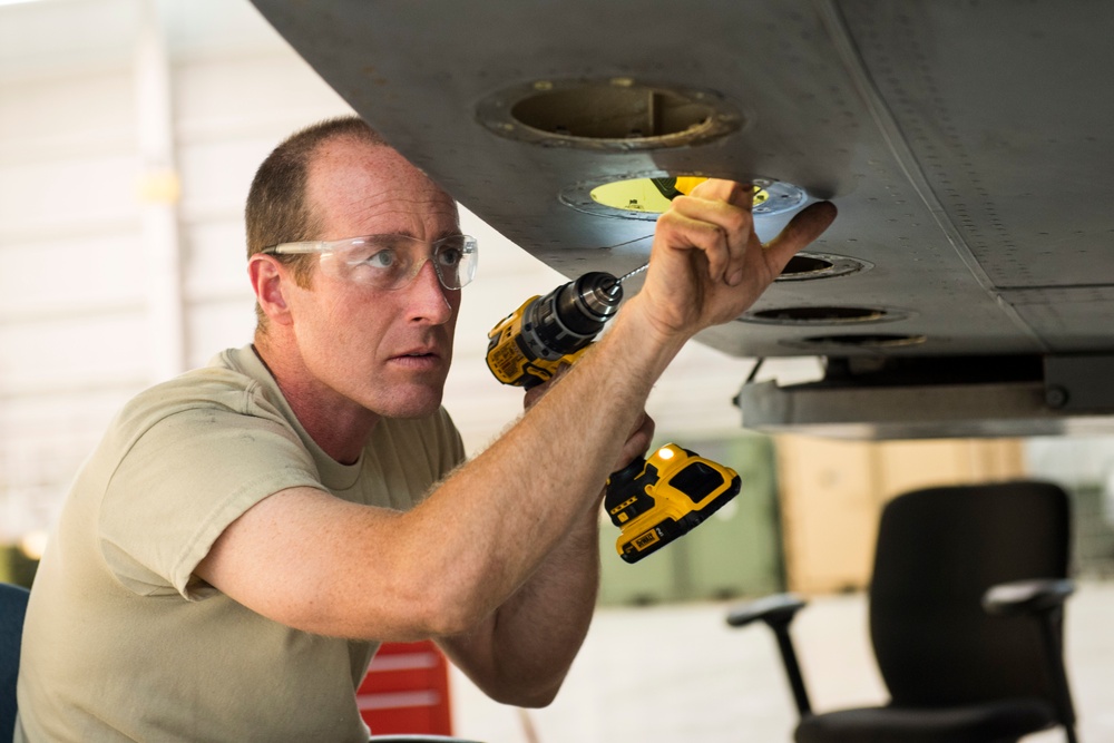 Maintainers repair corrosion on aircraft cargo ramp