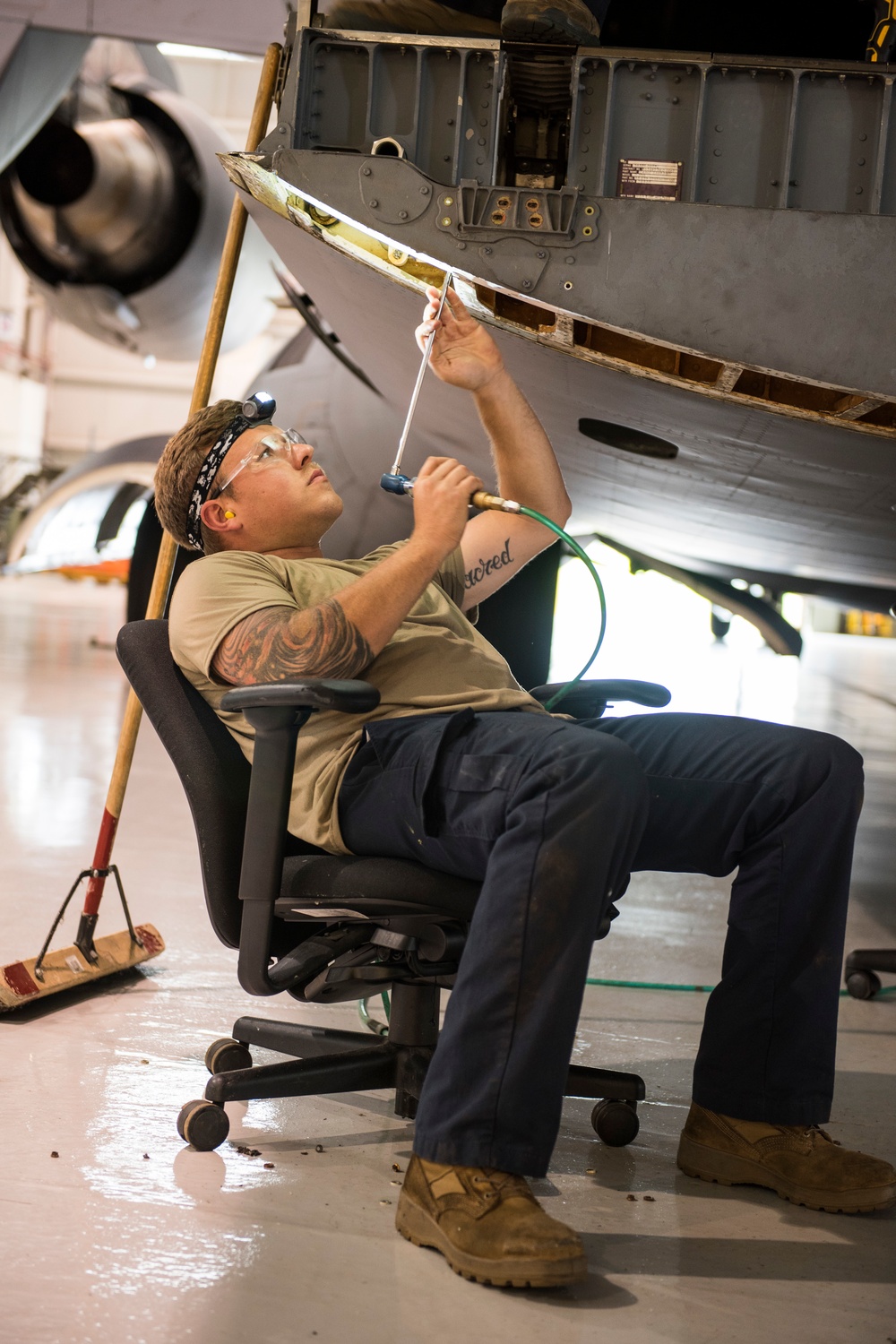 Maintainers repair corrosion on aircraft cargo ramp