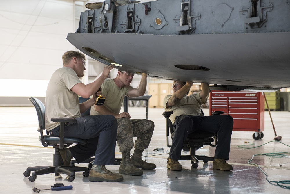 Maintainers repair corrosion on aircraft cargo ramp