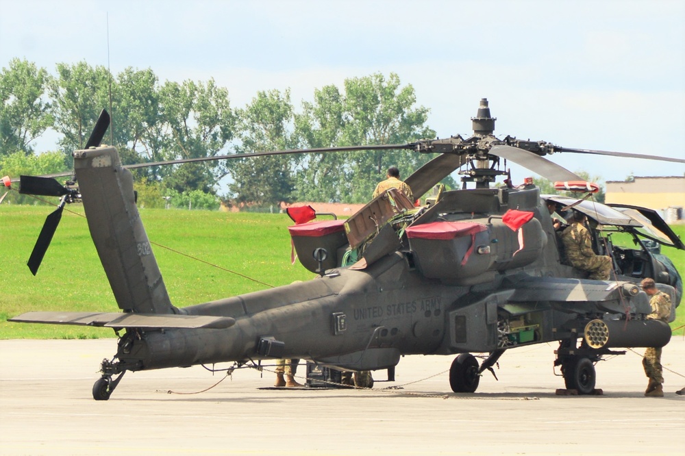 A Soldier performing maintenance on an Apache