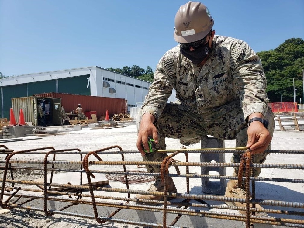 U.S. Navy Seabees with NMCB-5’s Detail Sasebo construct two pre-engineered buildings for Naval Beach Unit 7