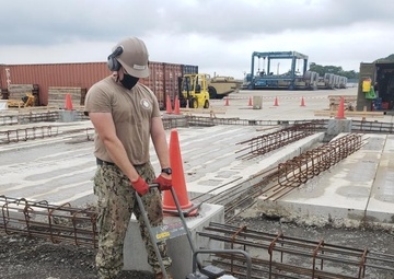 U.S. Navy Seabees with NMCB-5’s Detail Sasebo construct two pre-engineered buildings for Naval Beach Unit 7