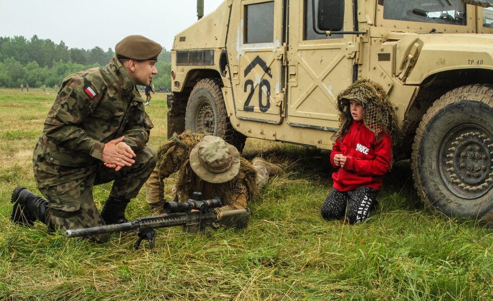 Soldiers from the U.S. and Poland Polish host local children for base visit