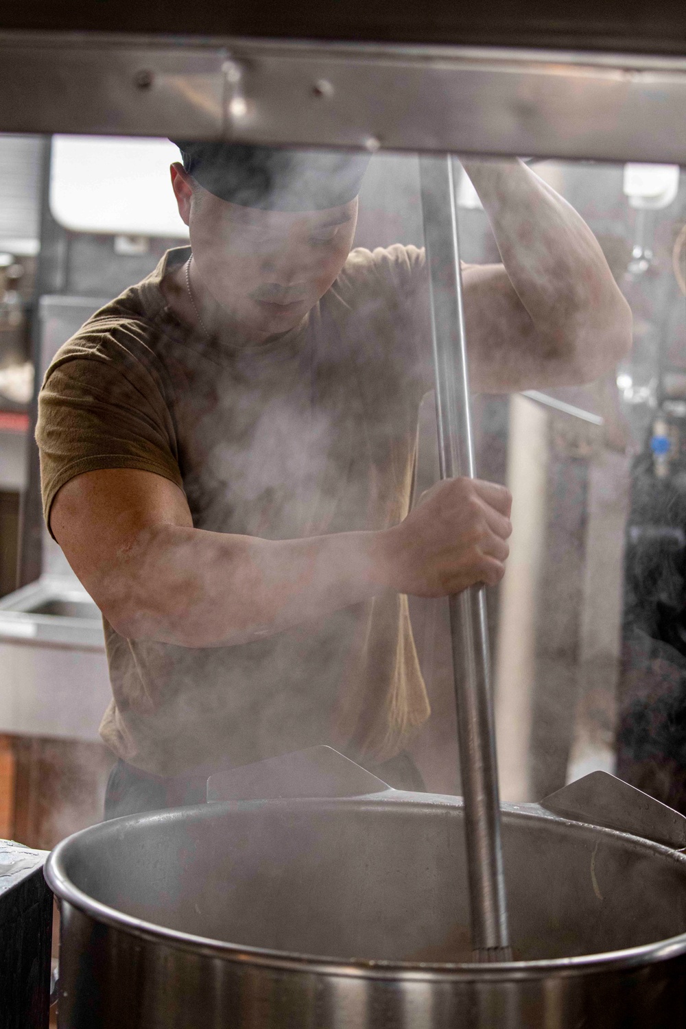 Sailors and Marines cook in the galley