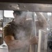 Sailors and Marines cook in the galley