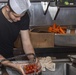 Sailors and Marines cook in the galley