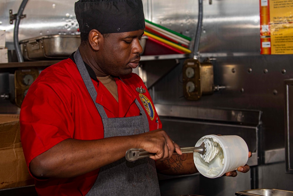 Sailors and Marines cook in the galley