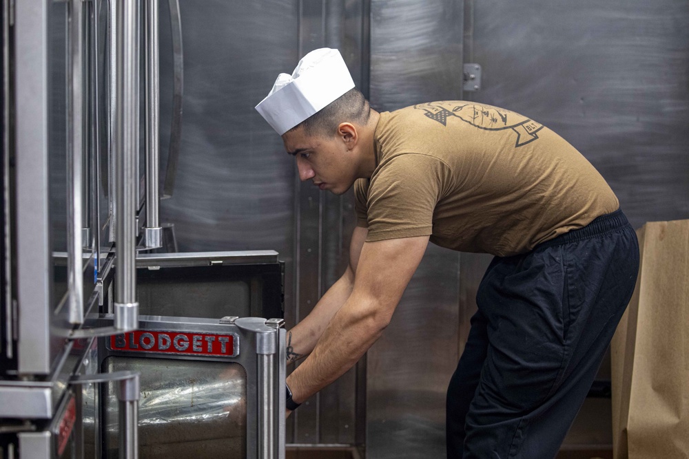 Sailors and Marines cook in the galley