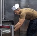 Sailors and Marines cook in the galley