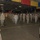 A formation of U.S. Air Force military personnel standing at attention inside a large hangar or warehouse facility. All personnel are wearing face masks, suggesting this was taken during the COVID-19 pandemic period. Two senior personnel appear to be addressing or inspecting the formation from the foreground.