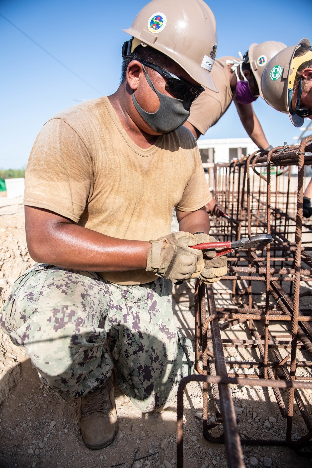 Seabees assigned to Naval Mobile Construction Battalion (NMCB) work on reinforcement bars for concrete footers and grade beams during a military working dog kennel project on board Naval Station Rota, Spain.