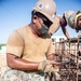 Seabees assigned to Naval Mobile Construction Battalion (NMCB) work on reinforcement bars for concrete footers and grade beams during a military working dog kennel project on board Naval Station Rota, Spain.