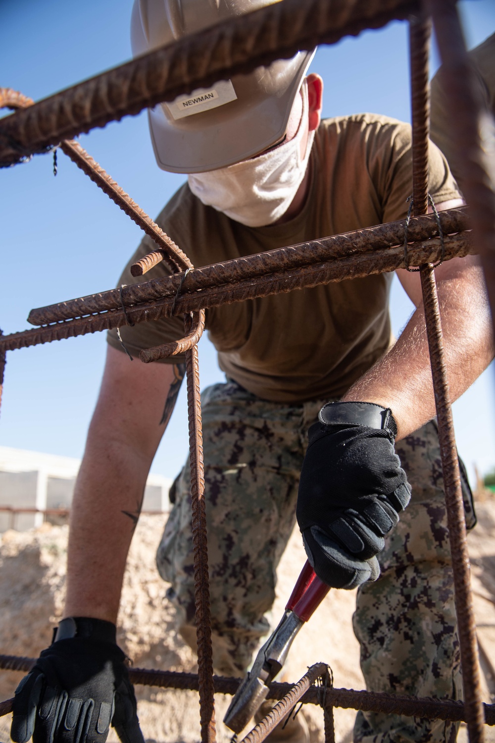 Seabees assigned to Naval Mobile Construction Battalion (NMCB) work on reinforcement bars for concrete footers and grade beams during a military working dog kennel project on board Naval Station Rota, Spain.