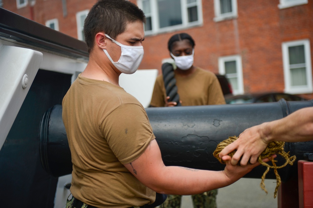 Sailors assigned to USS Constitution demonstrate how guns would have been fired during the age of sail