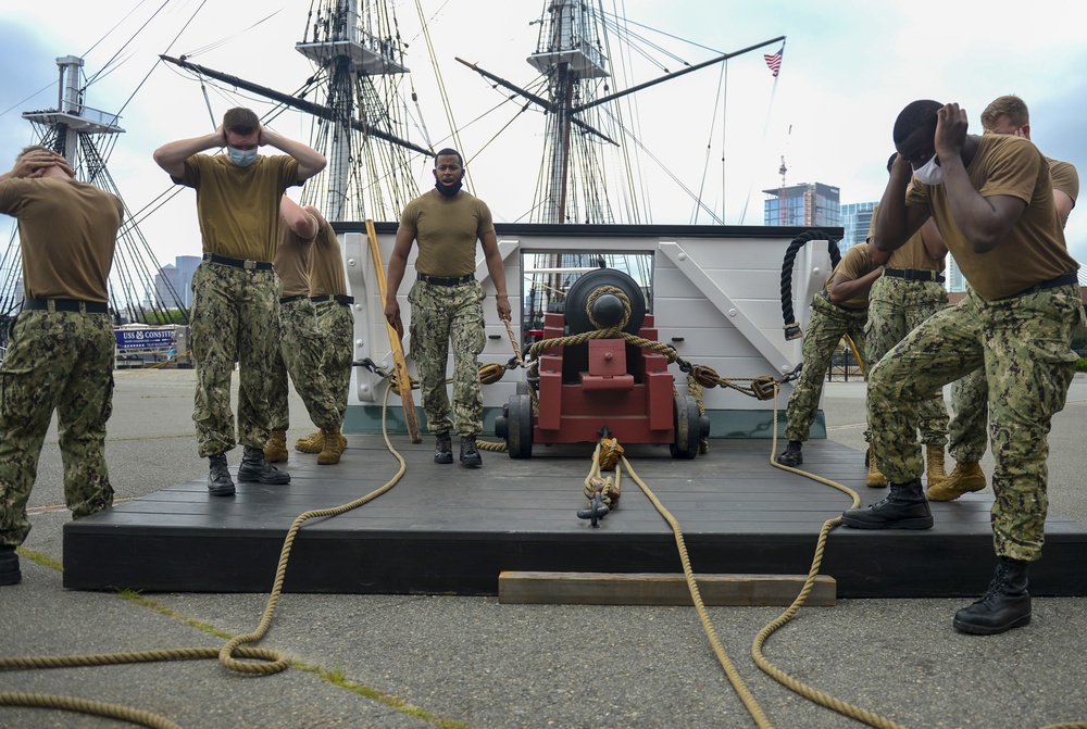 Sailors assigned to USS Constitution demonstrate how guns would have been fired during the age of sail