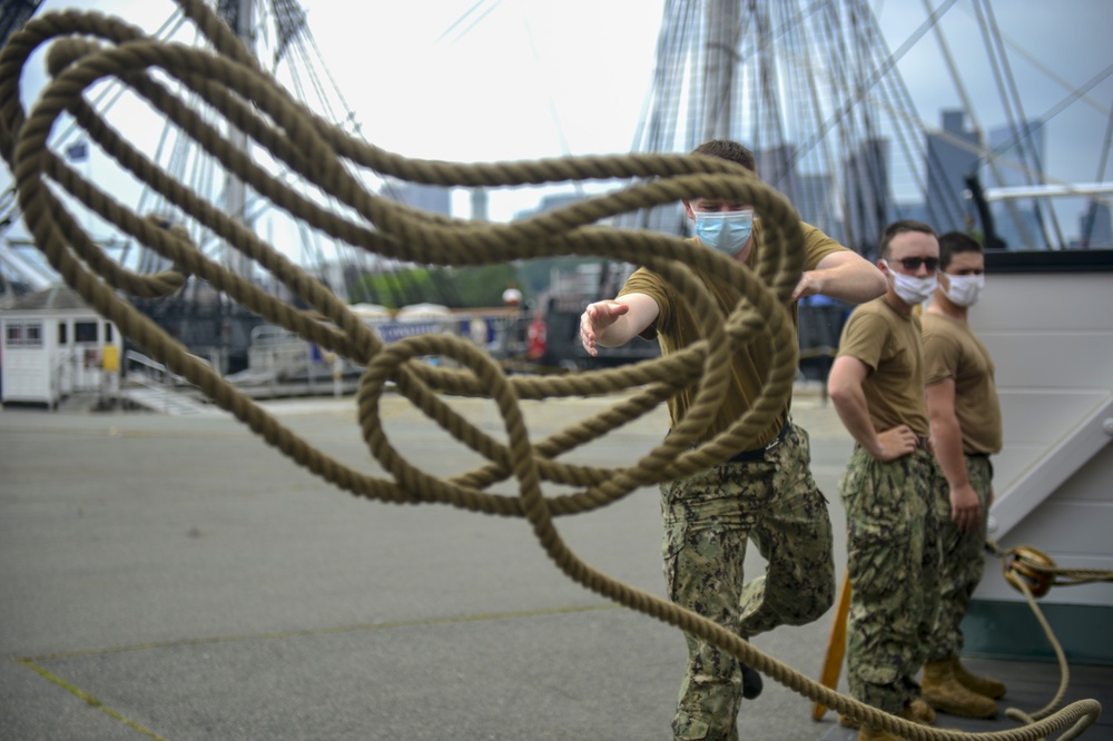 Sailors assigned to USS Constitution demonstrate how guns would have been fired during the age of sail