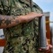 Airman Olivia Lawrence, assigned to USS Constitution, poses with a plugged and shined 40mm round from the saluting onboard Constitution