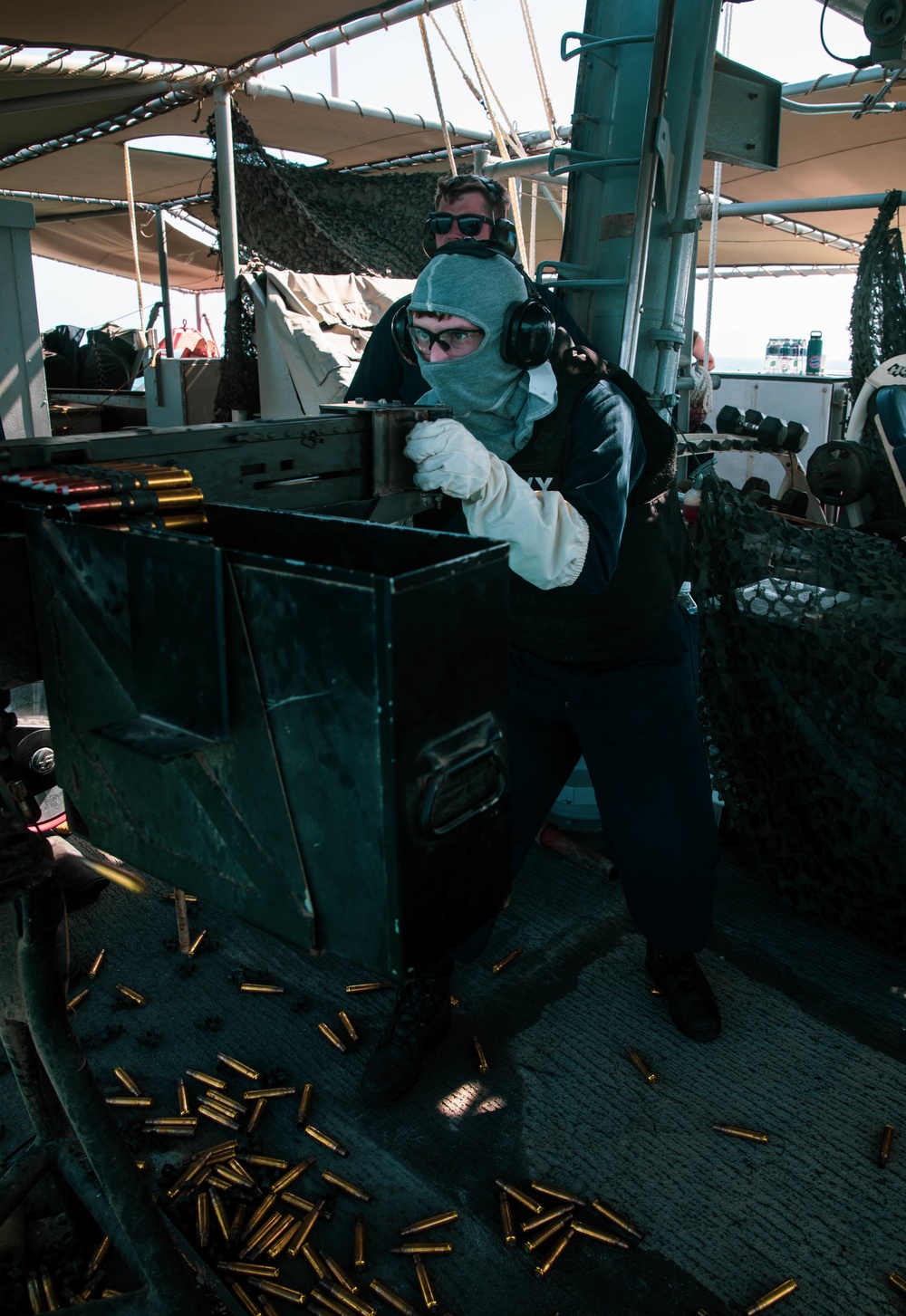 Mineman 2nd Class Nathan Milburger fires a .50 cal machine gun