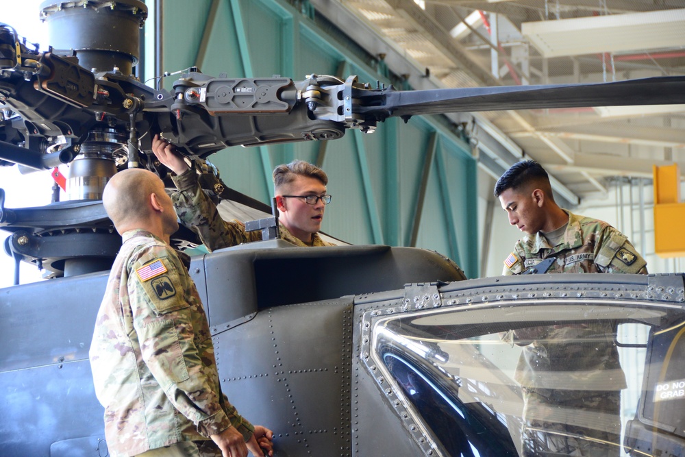 Soldier working on Apache rotor section