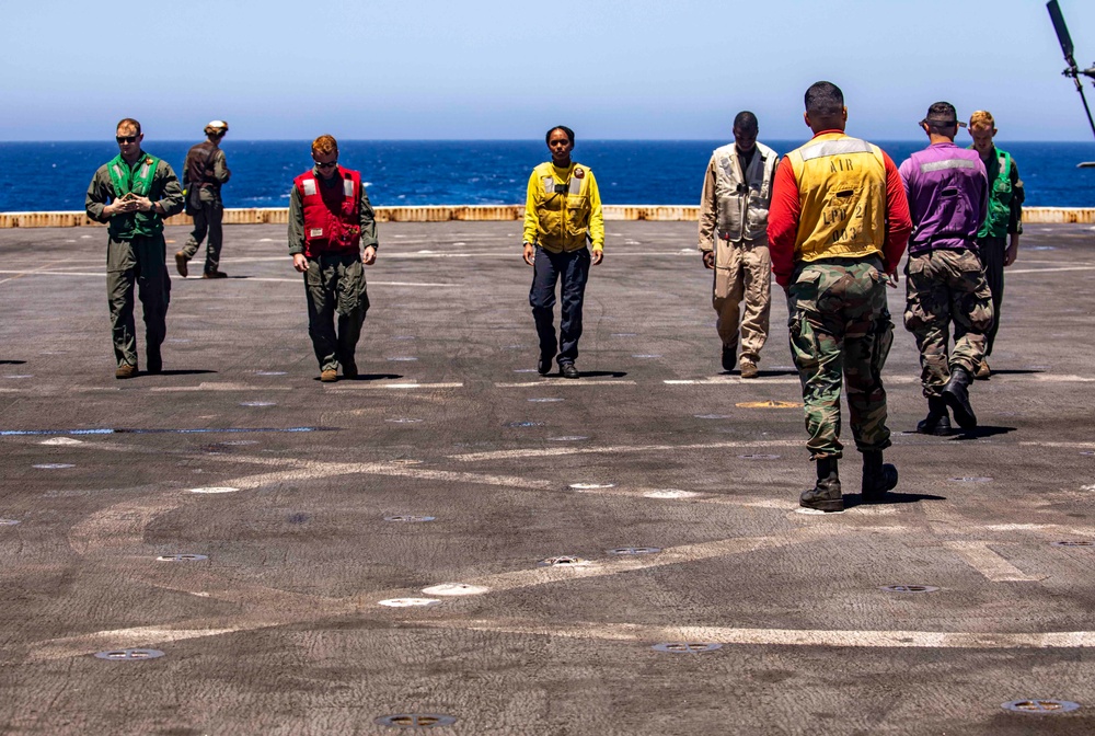 Sailors and Marines work on the flight deck aboard the New York