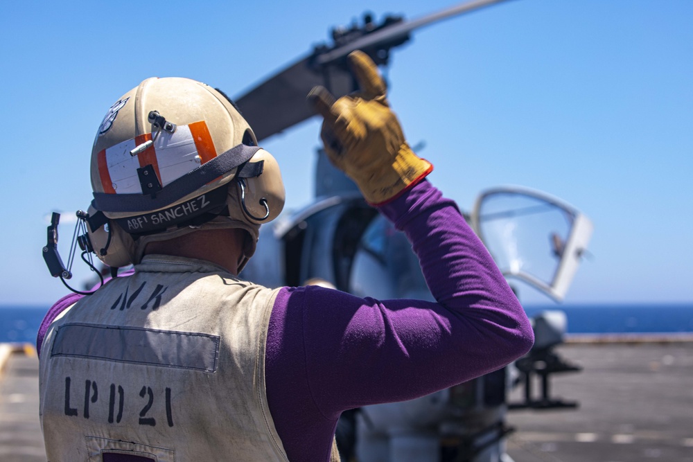 Sailors and Marines work on the flight deck aboard the New York