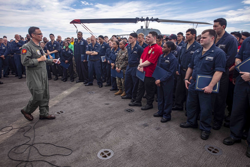 Sailors attend a All hands call aboard the USS New York