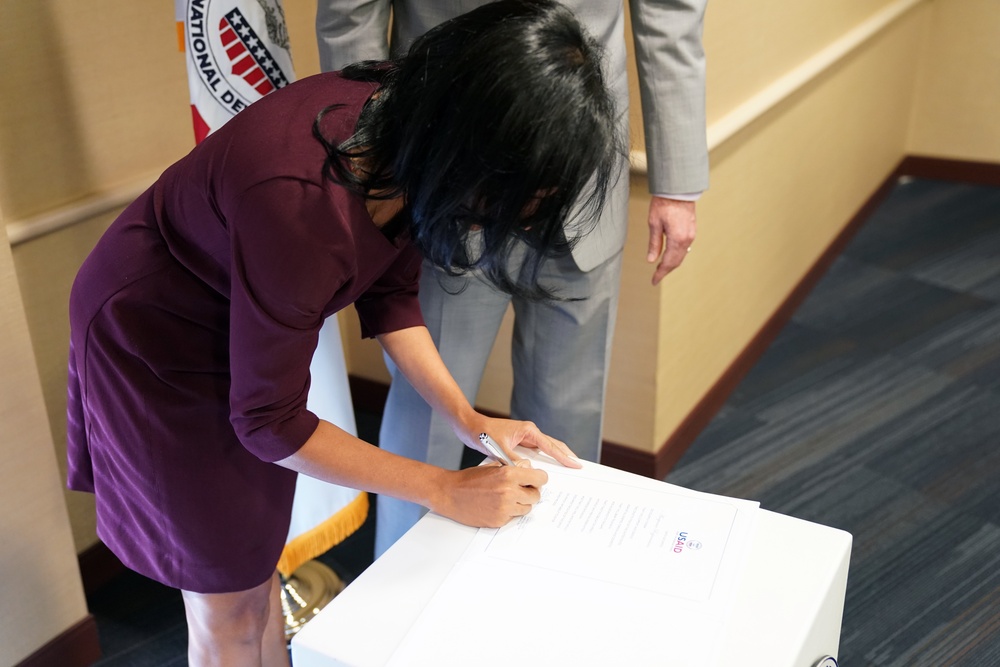 Signing in ceremony for Anu Rajaraman as Mission Director of Guatemala