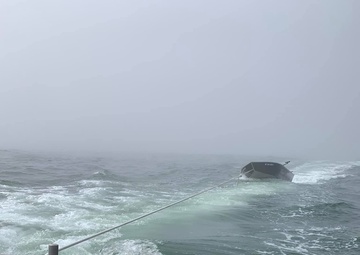 Coast Guard rescues 3 from capsized vessel