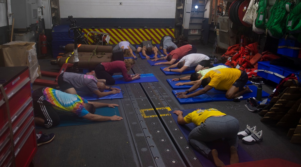 USS Roosevelt Sailors practice yoga