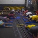 USS Roosevelt Sailors practice yoga