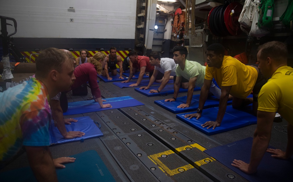 USS Roosevelt Sailors practice yoga