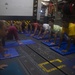 USS Roosevelt Sailors practice yoga