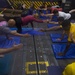 USS Roosevelt Sailors practice yoga