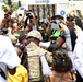 Cal Guard's 79th Infantry Brigade Combat Team Chaplain prays with protesters