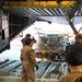 Reserve and active-duty Sailors assigned to Norfolk Navy-operated Air Mobility Command Air Terminal load palettes onto a C-5 military cargo plane