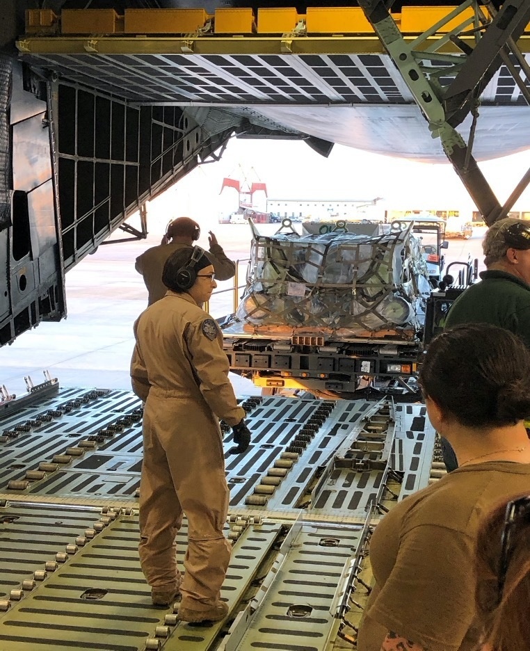 Reserve and active-duty Sailors assigned to Norfolk Navy-operated Air Mobility Command Air Terminal load palettes onto a C-5 military cargo plane