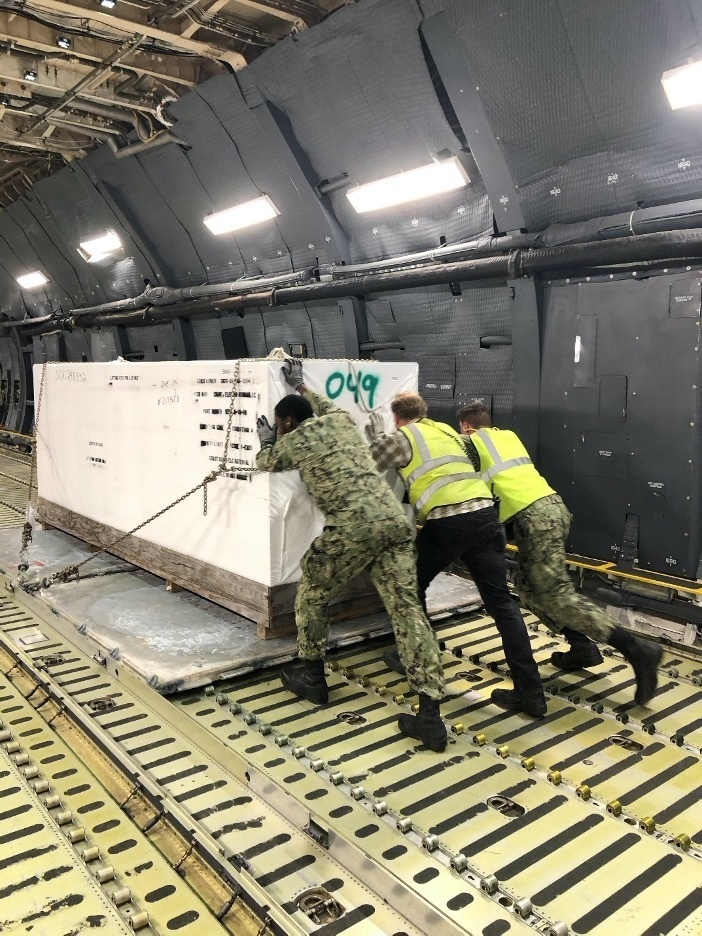 Reserve and active-duty Sailors assigned to Norfolk Navy-operated Air Mobility Command Air Terminal load palettes onto a C-5 military cargo plane